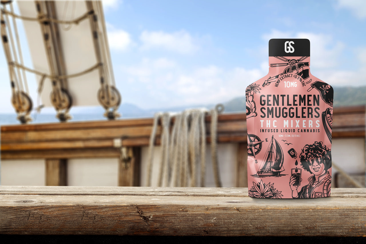 Gentlemen Smugglers THC Mixer pouch on a rustic wooden boat deck with sail ropes and a blue sky background.