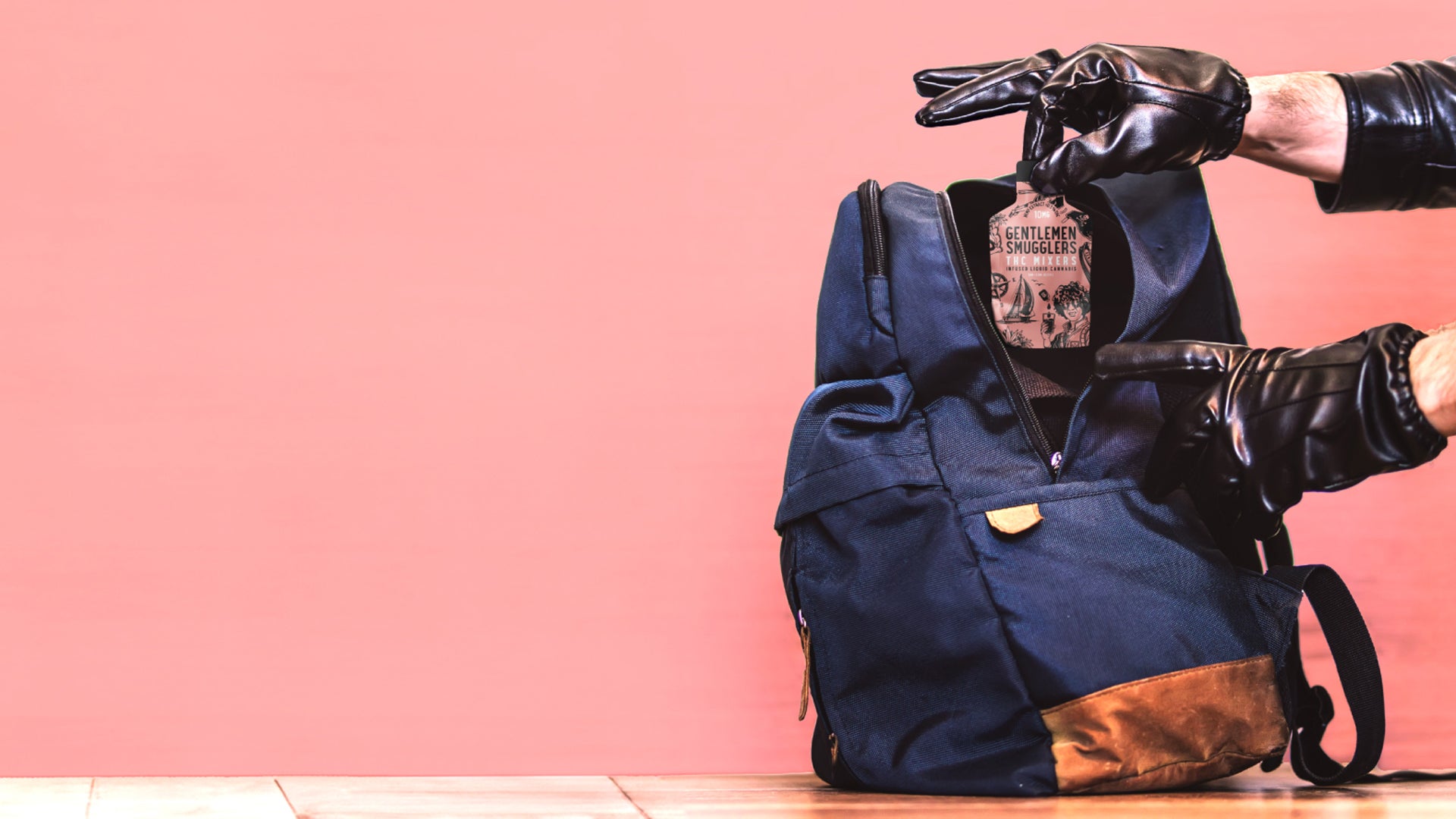 A man with black gloves putting a Gentlemen Smugglers SIPS 10mg pouch into a backpack.